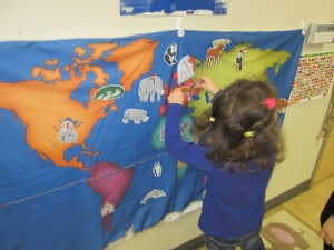 preschooler with flag map